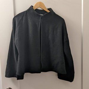 Cropped black wool cape with sleeves